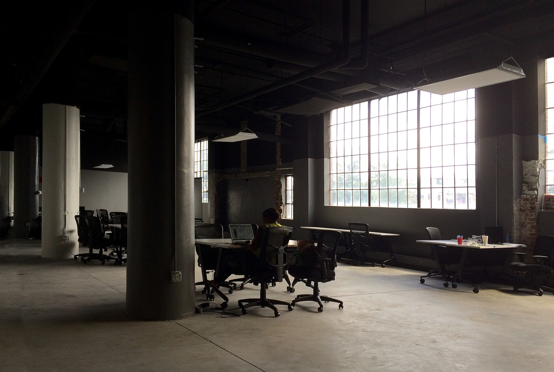 A person working alone in a large office
